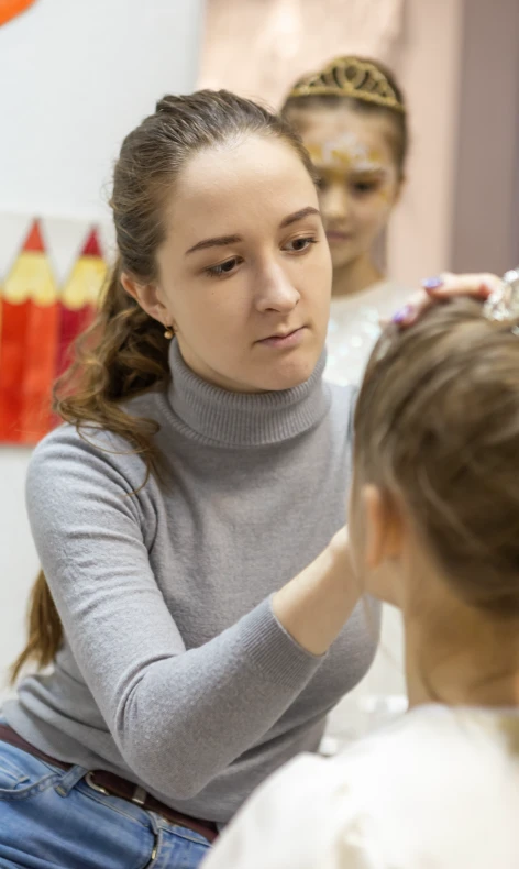 Face painter from BloomART drawing on a girl's face at kids party in Zurich