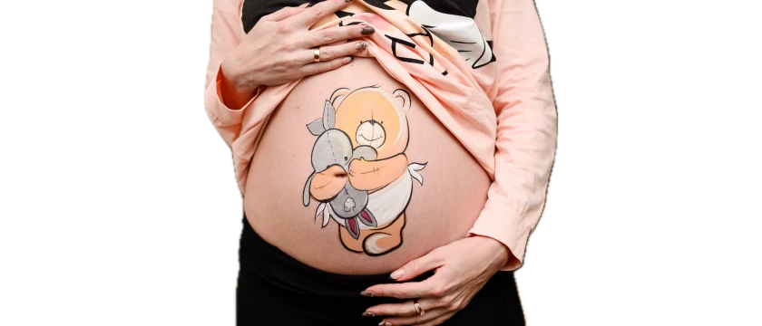 Pregnant belly painted with cartoon-style baby in a flower