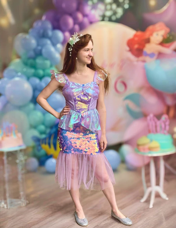 Entertainer posing in pastel setup with balloons