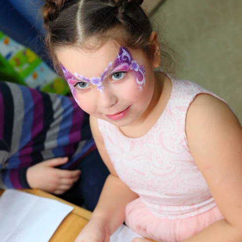 Girl with purple and pink butterfly face paint