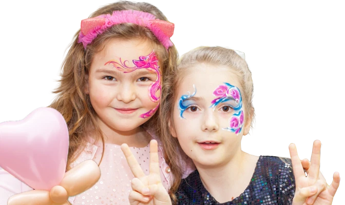 Two girls with beautiful face art and balloon heart, smiling at the camera